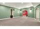 Spacious recreation room with carpeted floors, fireplace, speakers, and view into other rooms at 1398 Penny Ln, Greenfield, IN 46140