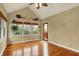 Sun-filled sun room featuring hardwood floors, windows, and views of the backyard at 1398 Penny Ln, Greenfield, IN 46140