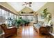 Peaceful sunroom filled with plants and wicker furniture at 1398 Penny Ln, Greenfield, IN 46140