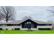 Charming single-story home with stone accents, large windows, and a well-maintained lawn at 2110 Round Barn Rd, Anderson, IN 46017