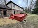 Spacious back deck is ideal for entertaining with its fresh paint and backyard access at 409 Lansdowne Rd, Indianapolis, IN 46234