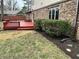 Backyard with well maintained lawn, privacy bushes, and access to the back deck at 409 Lansdowne Rd, Indianapolis, IN 46234
