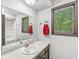 Bright bathroom featuring a sink, countertop, and a window with a view at 409 Lansdowne Rd, Indianapolis, IN 46234