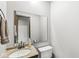Cozy bathroom featuring a modern vanity, a large mirror, and a toilet, all bathed in natural light at 409 Lansdowne Rd, Indianapolis, IN 46234