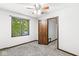 Bedroom features carpet, a window, and a paneled door at 409 Lansdowne Rd, Indianapolis, IN 46234