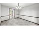 Simple dining room featuring carpet, trim, and light fixture at 409 Lansdowne Rd, Indianapolis, IN 46234