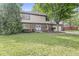 Charming two-story home with well-maintained front yard and mature trees at 409 Lansdowne Rd, Indianapolis, IN 46234
