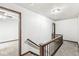 Hallway with carpeted floor and wood railing at 409 Lansdowne Rd, Indianapolis, IN 46234