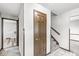 Hallway features tile flooring, wood door, and stairs to upper level at 409 Lansdowne Rd, Indianapolis, IN 46234