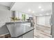 Bright kitchen featuring gray countertops, modern appliances, mosaic backsplash and access to an outdoor space at 409 Lansdowne Rd, Indianapolis, IN 46234