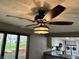 Stylish ceiling fan in dining area, adjacent to a renovated kitchen with updated appliances at 409 Lansdowne Rd, Indianapolis, IN 46234