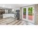 Modern kitchen with white cabinets and stainless steel appliances with access to backyard at 409 Lansdowne Rd, Indianapolis, IN 46234