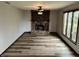 Open living room featuring new floors, a decorative fireplace and plenty of natural light at 409 Lansdowne Rd, Indianapolis, IN 46234