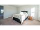 Well-lit bedroom featuring a cozy bed and a rustic side table at 4612 Amber Wood Dr, Indianapolis, IN 46235