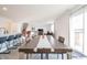 Open concept dining room with large wood table and access to deck at 4612 Amber Wood Dr, Indianapolis, IN 46235