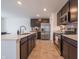 Spacious kitchen with dark cabinetry and stainless steel appliances at 4612 Amber Wood Dr, Indianapolis, IN 46235
