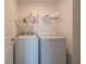 Laundry room with washer, dryer, and overhead storage at 4612 Amber Wood Dr, Indianapolis, IN 46235