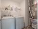 Laundry room with washer, dryer, and utility shelving at 4612 Amber Wood Dr, Indianapolis, IN 46235