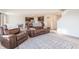 Bright living room with leather recliner chairs and area rug at 4612 Amber Wood Dr, Indianapolis, IN 46235