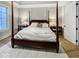 Spacious bedroom with four-poster bed, bedside tables with lamps, and plush carpeting at 467 Rayle Dr, Carmel, IN 46032