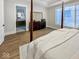 Primary bedroom featuring an ensuite bathroom, hardwood floors, and a large window at 467 Rayle Dr, Carmel, IN 46032