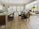 Open dining area with a modern chandelier, patio access, and seamless flow into the living area at 467 Rayle Dr, Carmel, IN 46032