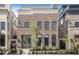 Charming brick home with symmetrical facade, large windows, and professionally landscaped front yard at 467 Rayle Dr, Carmel, IN 46032