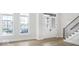 Bright foyer with hardwood floors, staircase, and natural light from large windows at 467 Rayle Dr, Carmel, IN 46032
