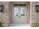 Elegant front door with sidelights, set in a classic brick facade and stone pathway at 467 Rayle Dr, Carmel, IN 46032