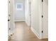 Hallway with hardwood floors, white walls, and doors leading to other rooms in the home at 467 Rayle Dr, Carmel, IN 46032