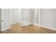 Hallway with hardwood floors, white walls, and doors leading to other rooms in the home at 467 Rayle Dr, Carmel, IN 46032