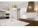 Well-equipped kitchen featuring modern appliances, a central island, and stylish pendant lighting at 467 Rayle Dr, Carmel, IN 46032