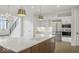 Kitchen island with seating, a sink, and stainless steel appliances, ideal for casual dining at 467 Rayle Dr, Carmel, IN 46032