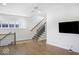 Upstairs landing with hardwood floors, staircase, and mounted television at 467 Rayle Dr, Carmel, IN 46032