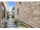 Landscape view with black rocks, stepping stones, plants, and a tall brick wall at 467 Rayle Dr, Carmel, IN 46032