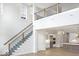 Bright living room with open floor plan, hardwood floors and staircase with metal railing at 467 Rayle Dr, Carmel, IN 46032