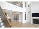 Bright living room featuring a fireplace and a staircase leading to the second story at 467 Rayle Dr, Carmel, IN 46032
