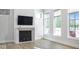 Cozy living room with fireplace, natural light, and hardwood flooring at 467 Rayle Dr, Carmel, IN 46032
