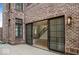 View of a brick patio with sliding doors that lead into the living room and stairs at 467 Rayle Dr, Carmel, IN 46032