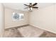 Carpeted bedroom with ceiling fan and window at 5921 Bastille Ln, Indianapolis, IN 46254