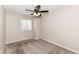 Carpeted bedroom with ceiling fan and window at 5921 Bastille Ln, Indianapolis, IN 46254