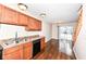 Eat-in kitchen with wood cabinets, black appliances, and access to backyard at 5921 Bastille Ln, Indianapolis, IN 46254