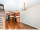Kitchen with dark wood cabinets, black appliances, and laminate flooring at 5921 Bastille Ln, Indianapolis, IN 46254