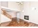 Living room with hardwood floors, fireplace, staircase, and high ceilings at 5921 Bastille Ln, Indianapolis, IN 46254