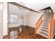 Spacious living room with hardwood floors, vaulted ceilings, fireplace, and staircase at 5921 Bastille Ln, Indianapolis, IN 46254