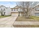 Two-story house with beige siding, brick accents, and a two-car garage at 10917 Delphi Dr, Camby, IN 46113