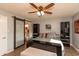 Main bedroom with a barn door, ceiling fan and en-suite bathroom at 11 Eastern Ave, Brownsburg, IN 46112