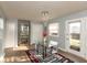 Dining room with glass table, modern chandelier and access to backyard at 11 Eastern Ave, Brownsburg, IN 46112