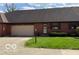 Charming brick home with an attached garage and a well-manicured lawn, creating curb appeal at 11 Eastern Ave, Brownsburg, IN 46112