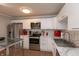 Modern kitchen with stainless steel appliances and white cabinetry at 11 Eastern Ave, Brownsburg, IN 46112